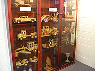 A range of handcracfted wooden heavy vehicle models on display
